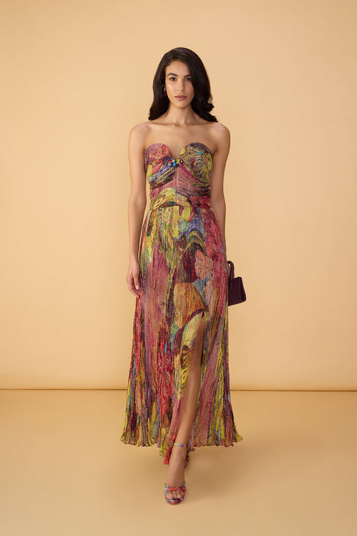 Woman wearing a colorful strapless dress on a beige background