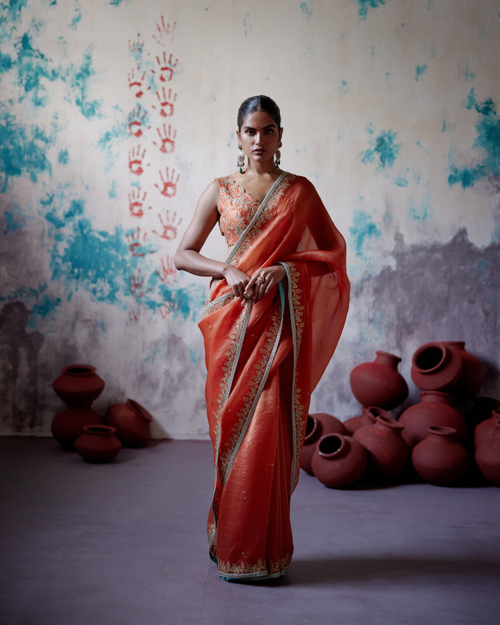 rust orange half and half saree with sleeveless blouse