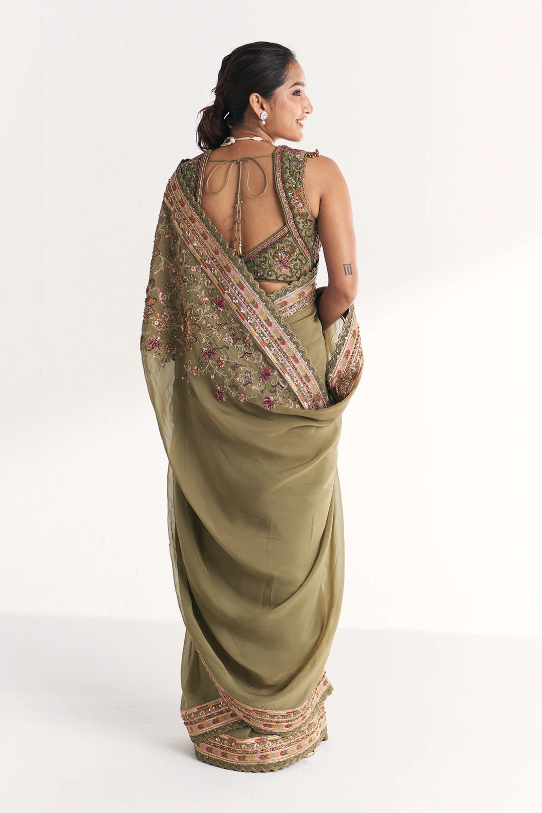 Woman wearing a traditional saree with a white background