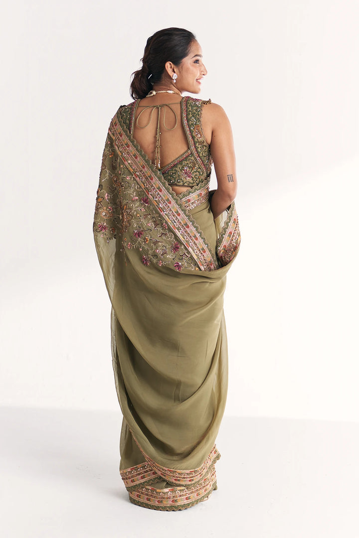 Woman wearing a traditional saree with a white background