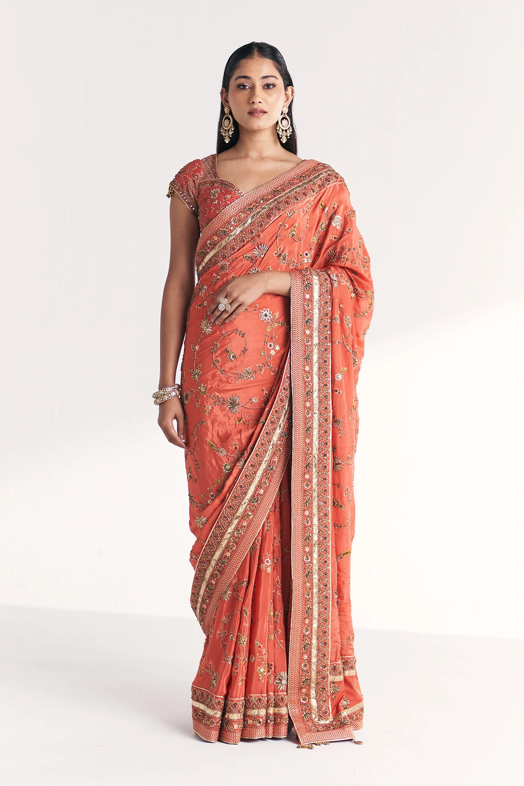 Woman wearing a traditional saree with a white background