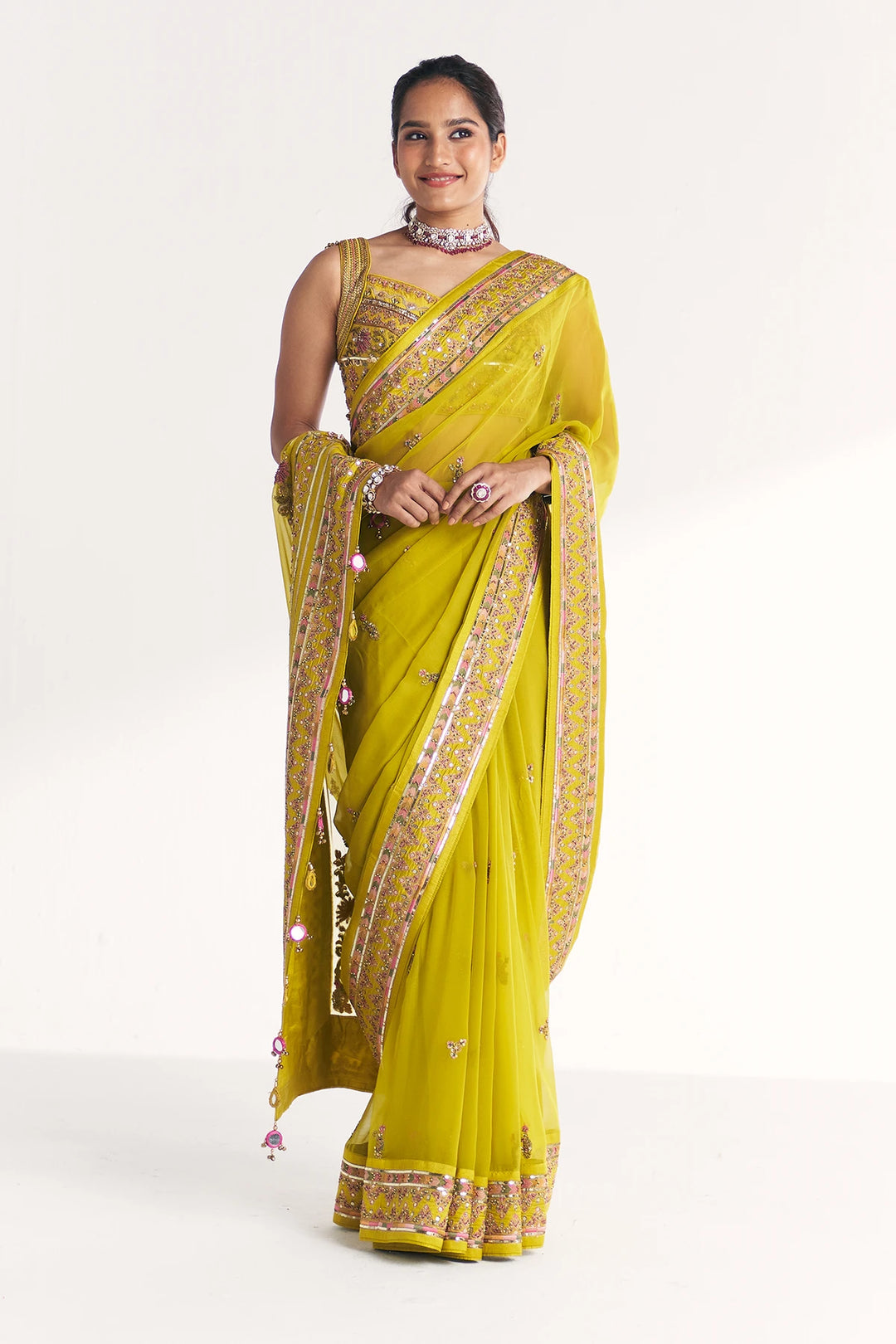 Woman wearing a yellow saree with a white background