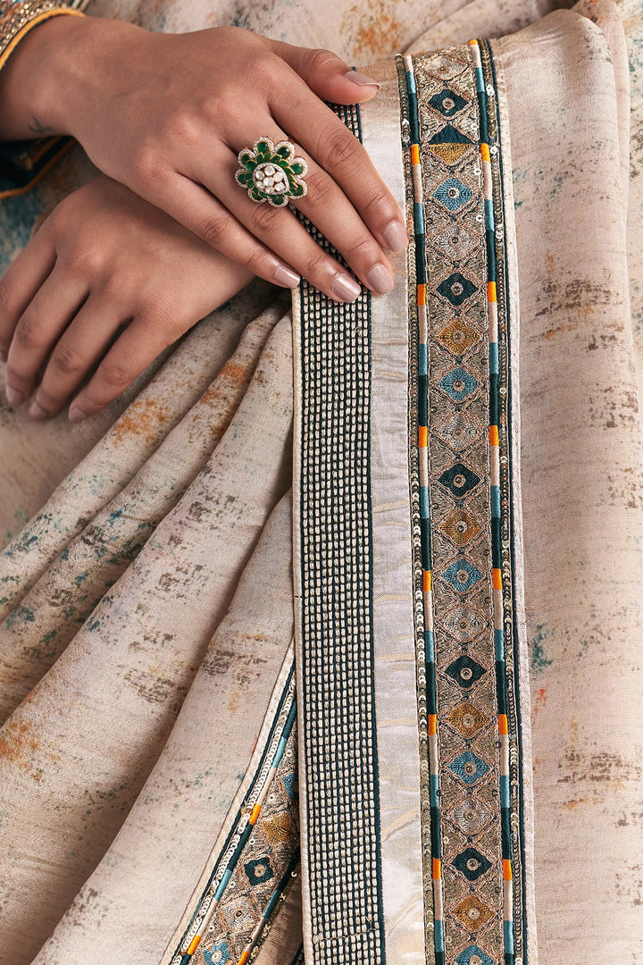 Close-up of a hand wearing a ring on a fabric background