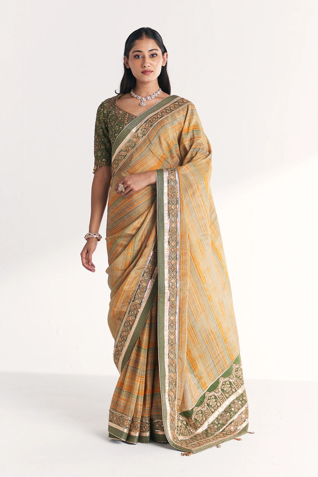 Woman wearing a traditional saree with a white background