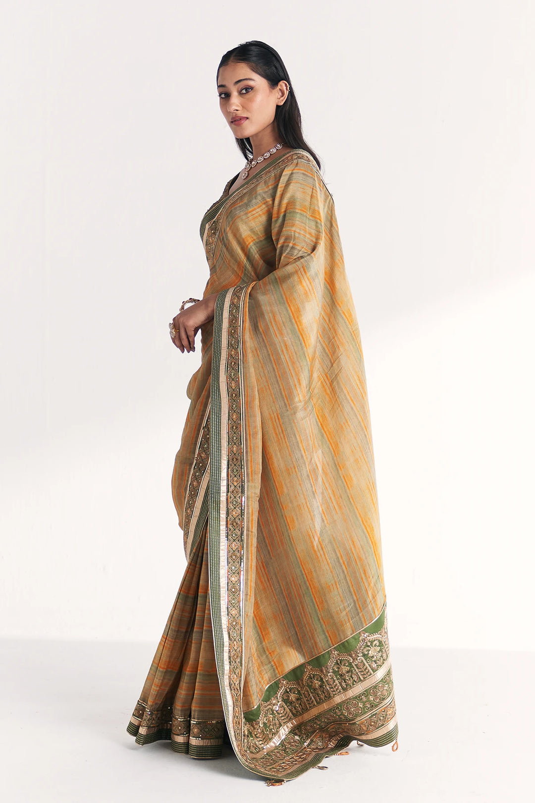 Woman wearing a traditional saree with a white background