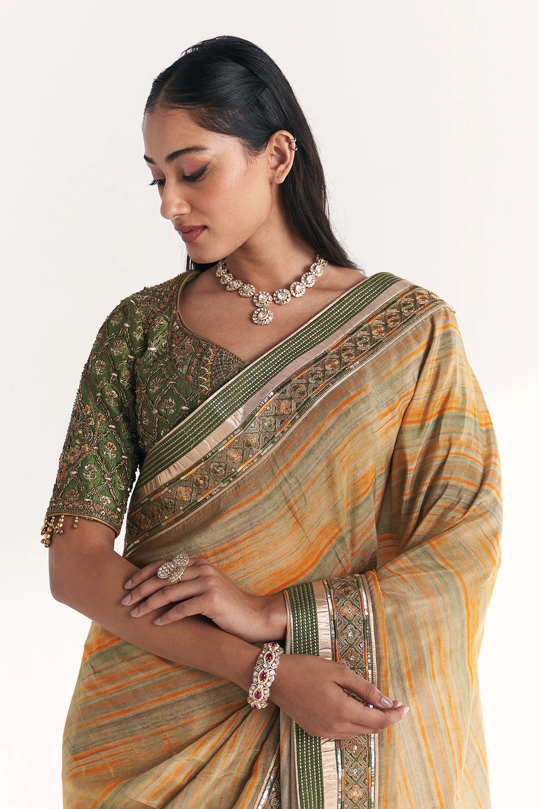 Woman wearing a traditional saree with a white background