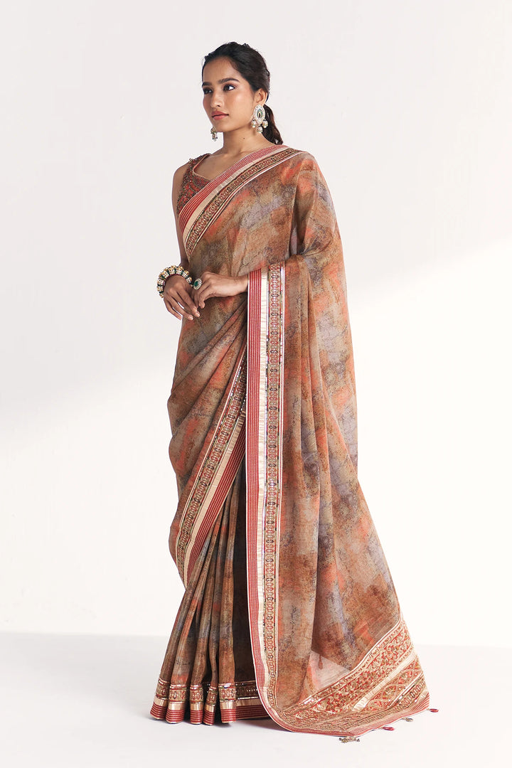 Woman wearing a traditional saree with a white background