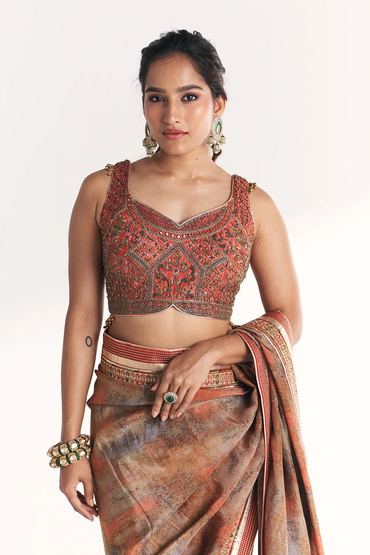 Woman wearing a traditional outfit with a blouse and saree on a white background