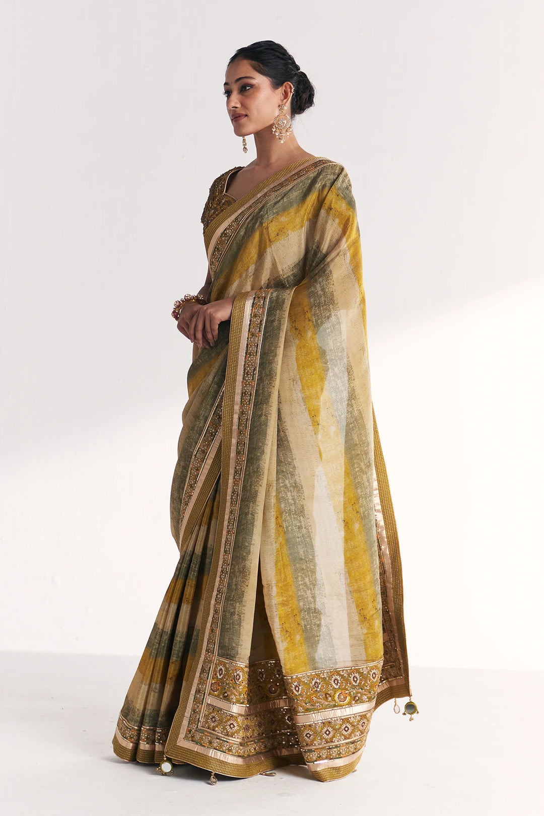 Woman wearing a traditional saree with a white background