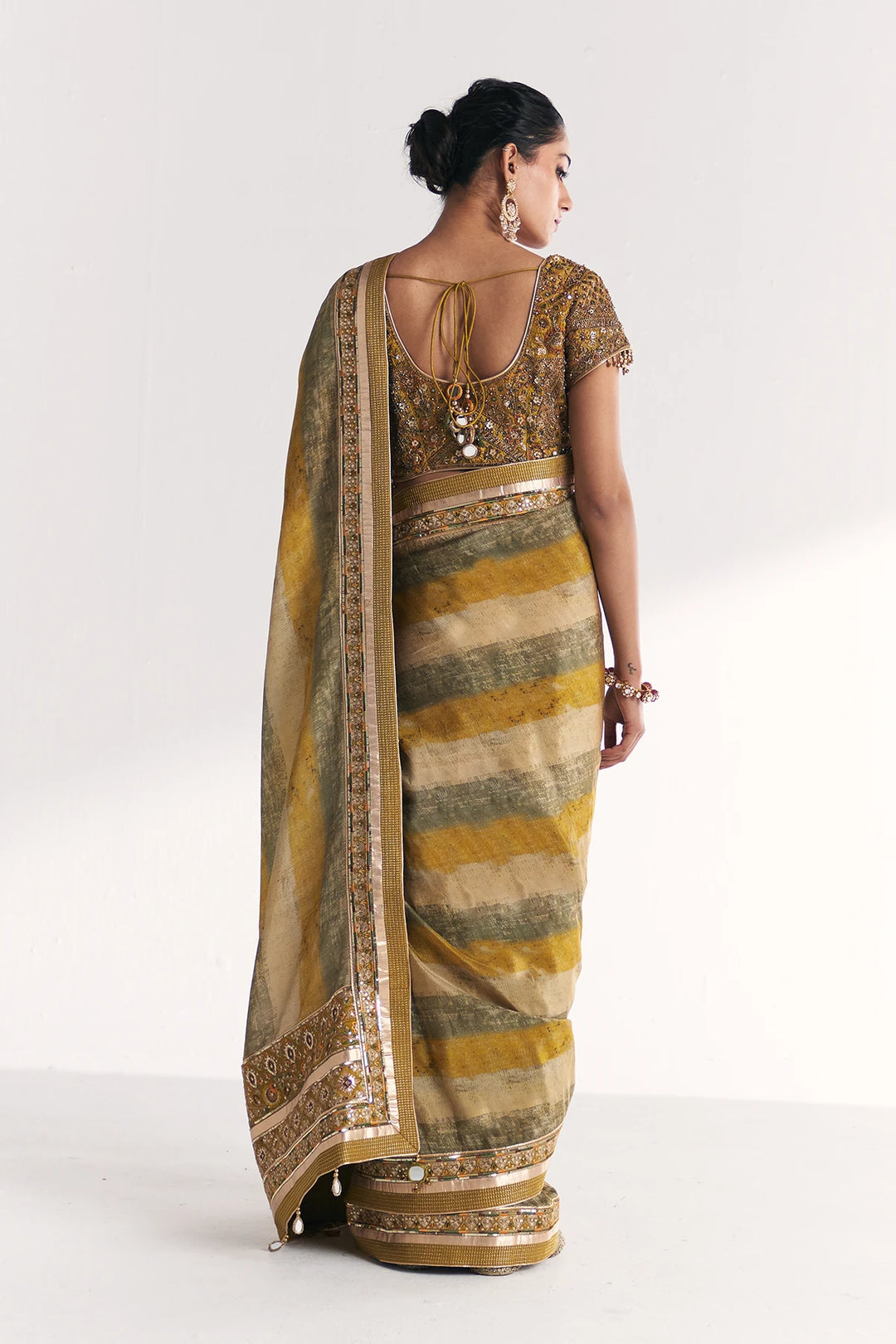 Woman wearing a traditional saree with a white background