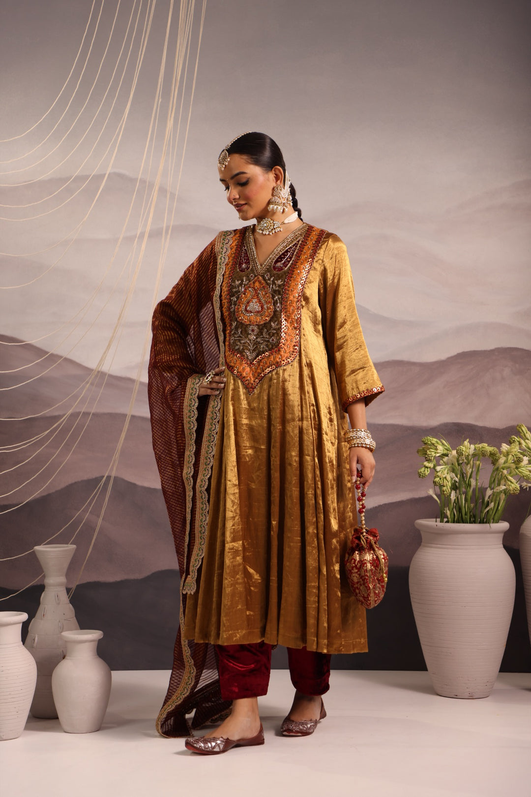 gold tissue kalidar with antique look yoke and maroon velvet salwar