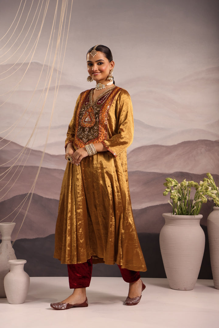 gold tissue kalidar with antique look yoke and maroon velvet salwar