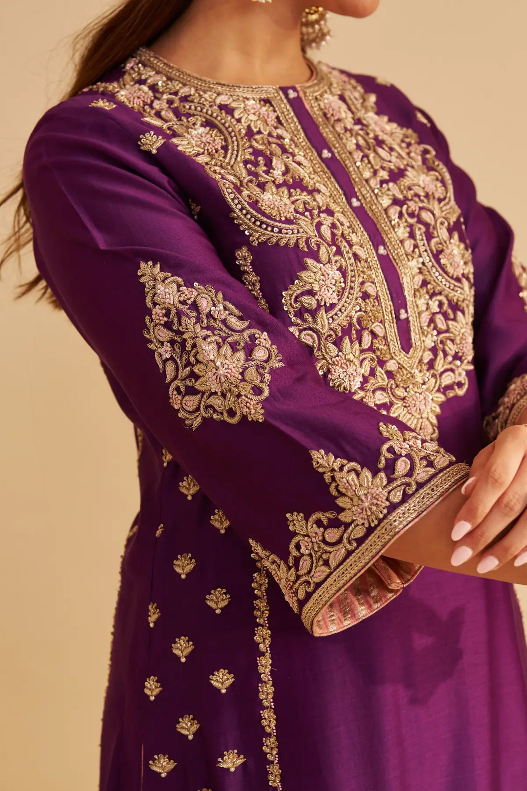 Purple embroidered Kurta with gold details on a beige background