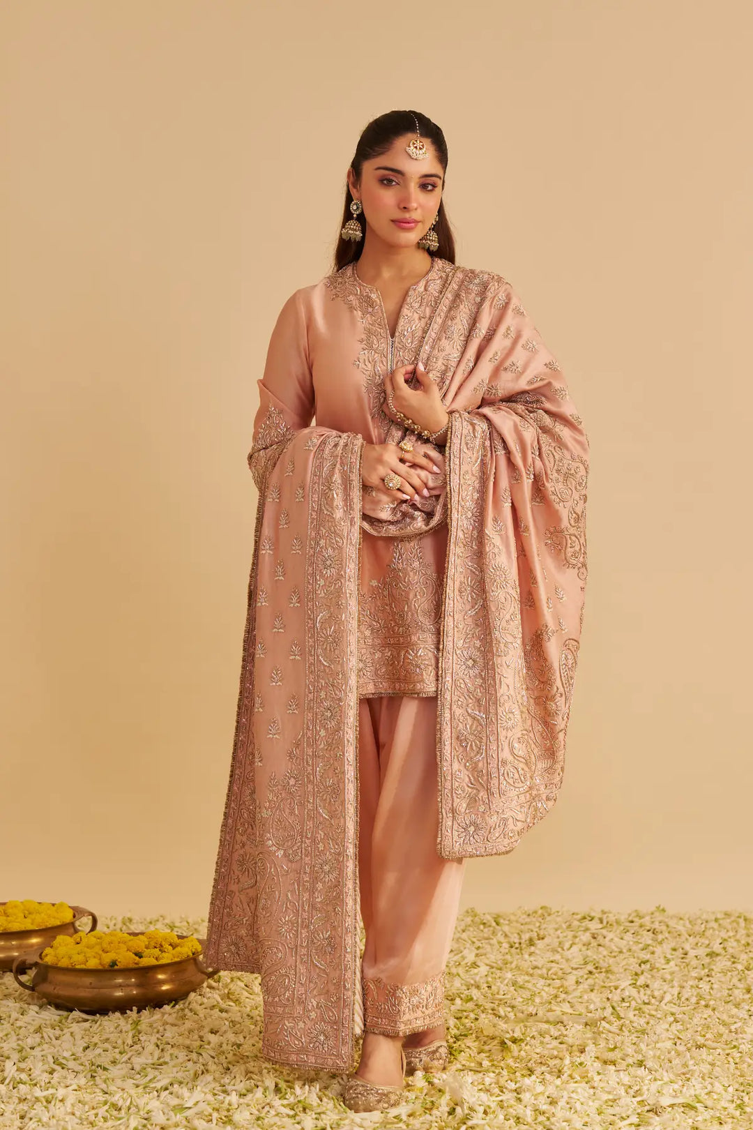 Woman in a traditional kurta with a beige background